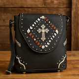 Black handbag with decorative elements on a wooden surface and background